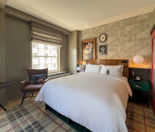 Queen bed inside decorated hotel room
