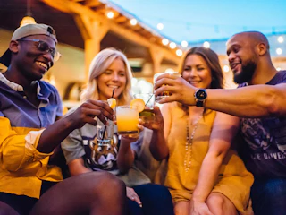 A group of friends enjoy a night out with drinks in Baton Rouge, LA