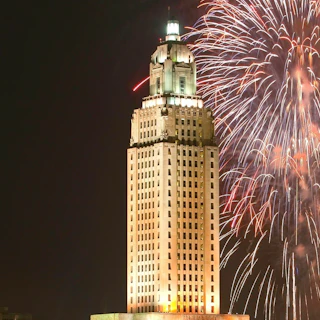 Fireworks in the night sky beind the illuminiated State Capitol building in Baton Rouge