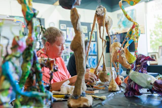 Artist in her studio working on a project