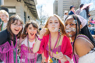 four girls at Spanish Town Mardi Gras Parade