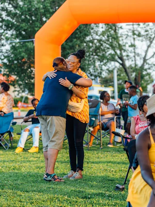 Two people embracing at a festival at a park in Baton Rouge