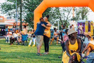 Two people embracing at a festival at a park in Baton Rouge